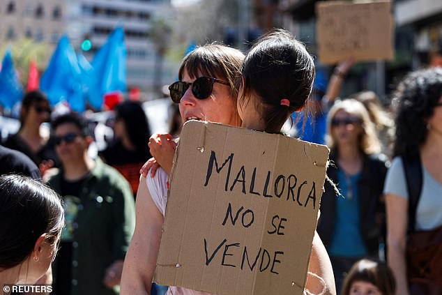 Mallorca is not for sale' reads a protest banner held by a girl in a march against housing prices and the impact of tourism on the residents of the Balearic Islands, in Palma, Mallorca, Spain, April 5,