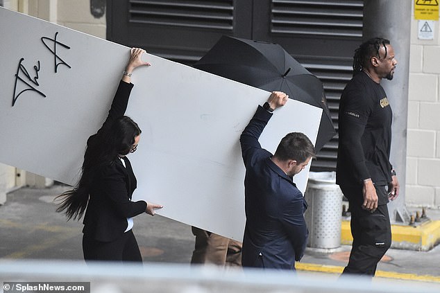 The rapper, who was released on £5M bail, was shielded by staff behind a large white board while leaving the five star Lowry Hotel where he was detained in the early hours of May 15