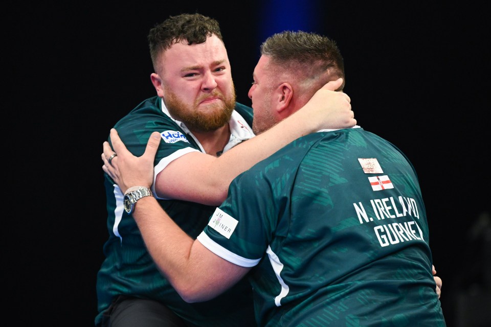 Josh Rock and Daryl Gurney of Northern Ireland celebrating a darts victory.