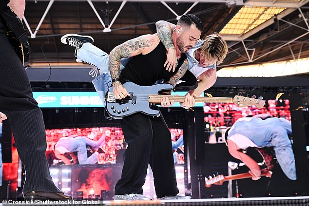 The boy bands went wild on stage and playfully wrestled
