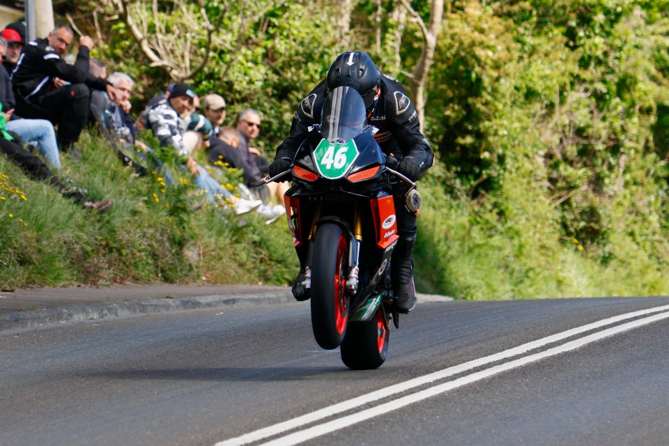 Motorcycle performing a wheelie during a race.