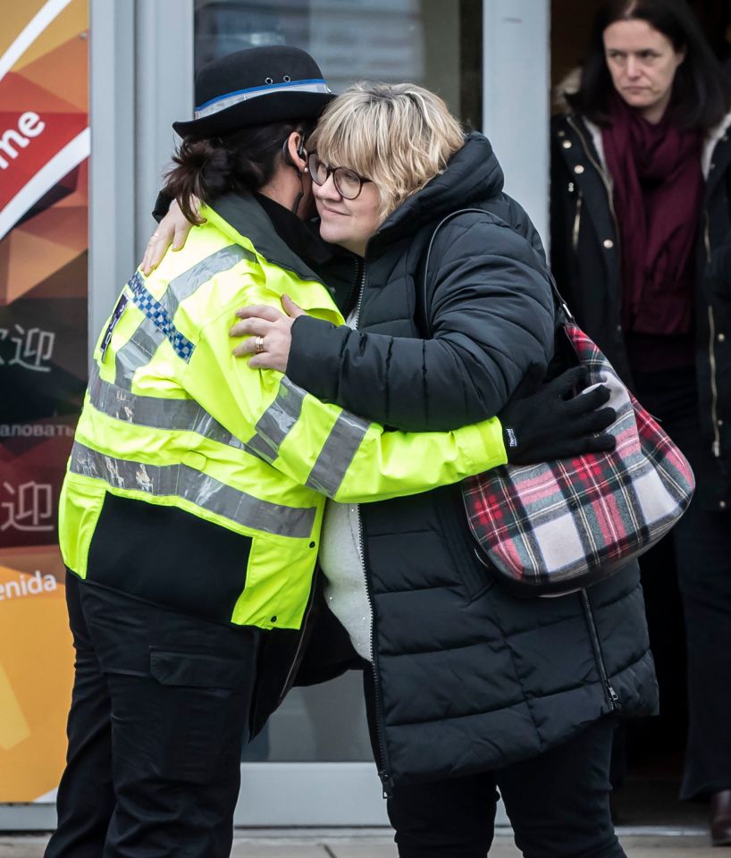 Lisa Squire, mother of missing student Libby Squire, hugs a police officer.