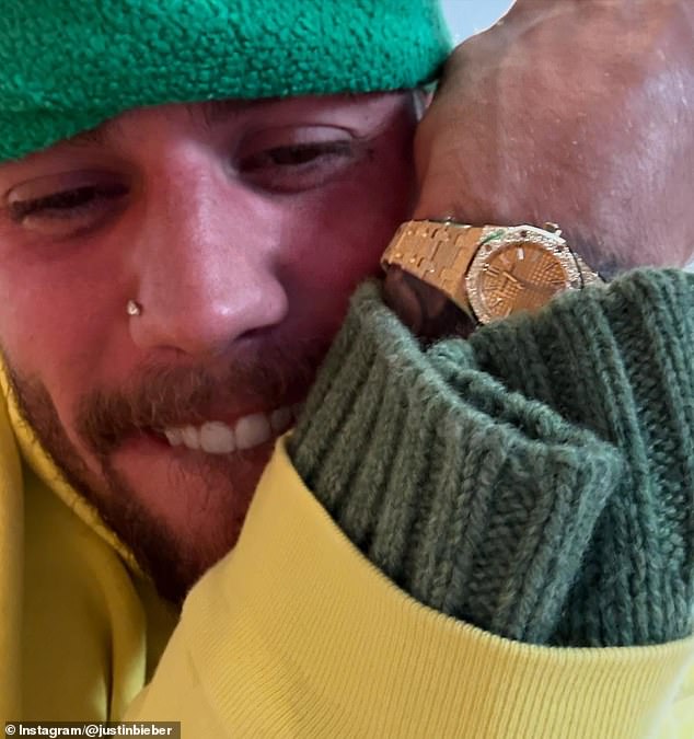 Several hours after posting his menacing message, Bieber seemed overjoyed at receiving a gold and diamond Audemars Piguet watch