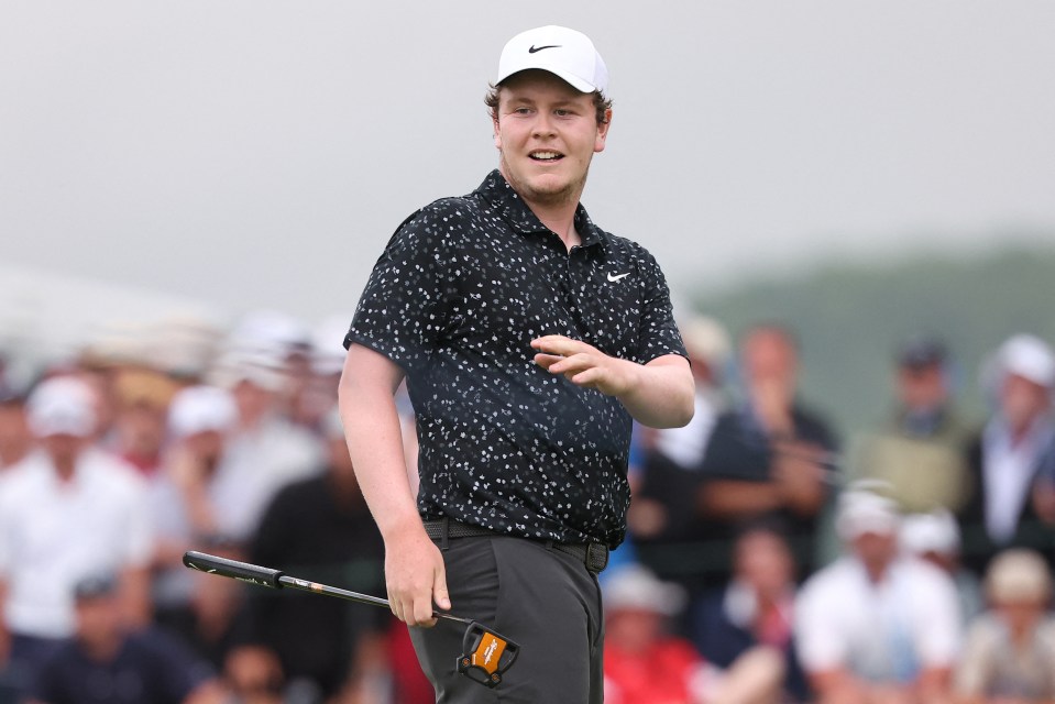 Robert MacIntyre prepares to putt on the 18th green.