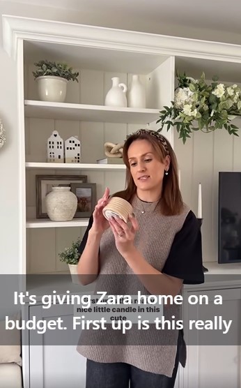 Woman holding a candle, similar to a Zara Home candle.