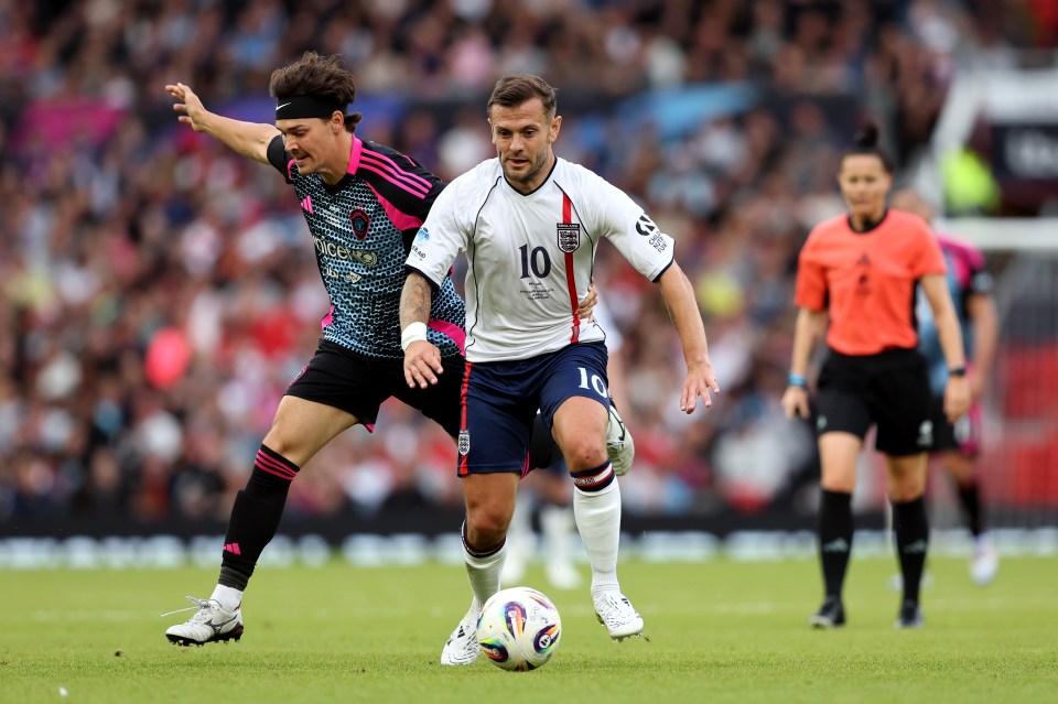 Jack Wilshere of England battles for possession during a soccer match.