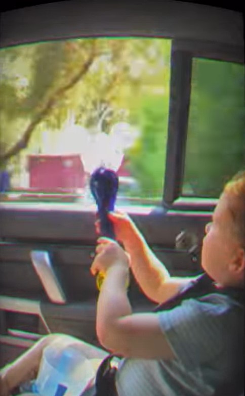 Child in car playing with toy.