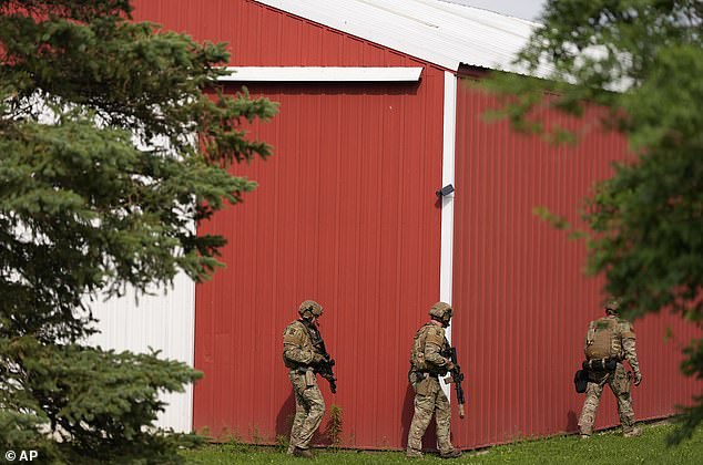 Camouflaged law enforcement agents carefully swept the area