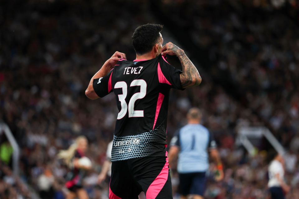 Carlos Tevez, number 32, celebrates scoring a goal for Soccer Aid for UNICEF.