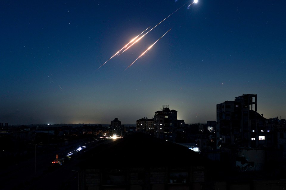 Trails of Iranian missiles over Gaza City at night.