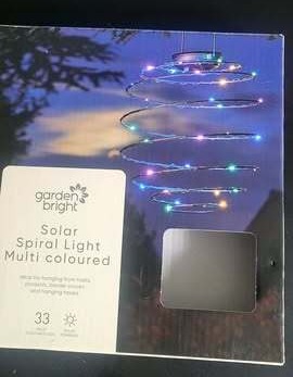 Box showing a multi-colored solar spiral light.