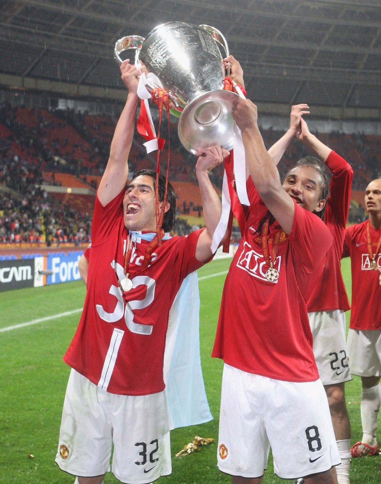 Carlos Tevez and Anderson of Manchester United celebrating with the UEFA Champions League trophy.
