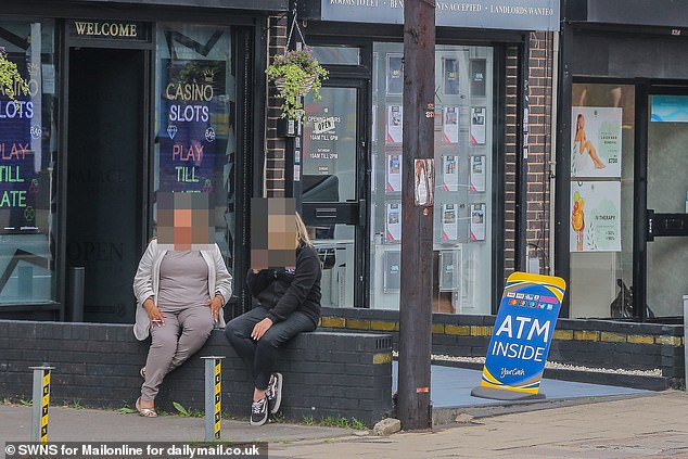 Two women sit outside a casino in Yardley, Birmingham this week
