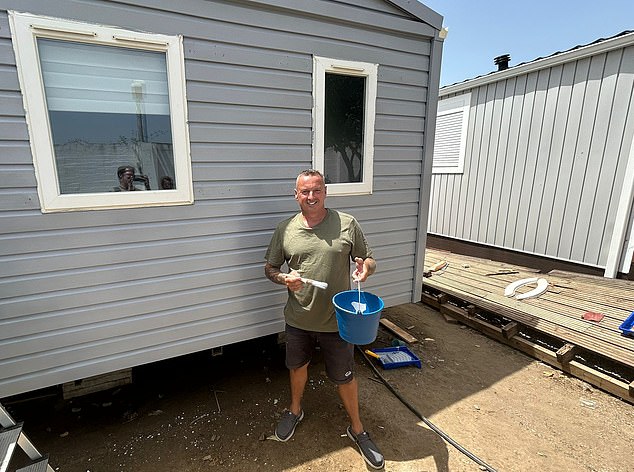 Part-time tradie Martin James, pictured painting his mobile home, has been living at Valle Niza for almost four years