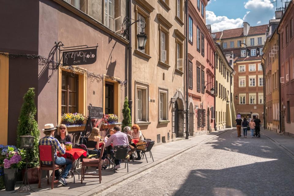 Tourists sitting outside a cafe in Warsaw's Old Town.