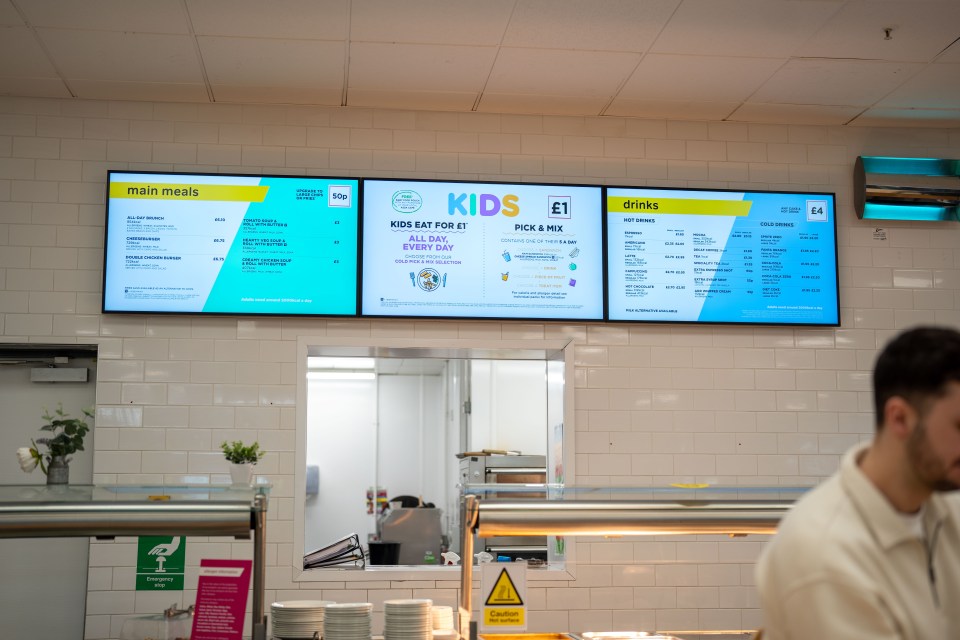 Digital menu boards displaying food and drink options.