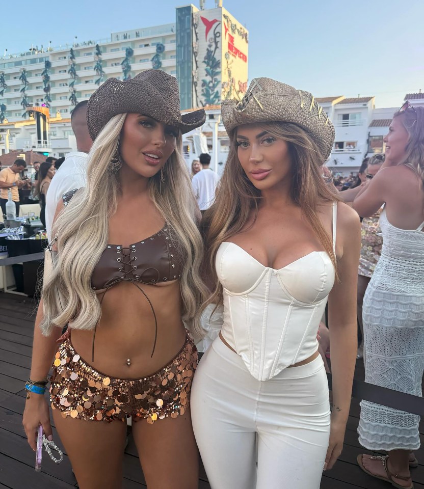 Two women wearing cowboy hats and party outfits at a club.