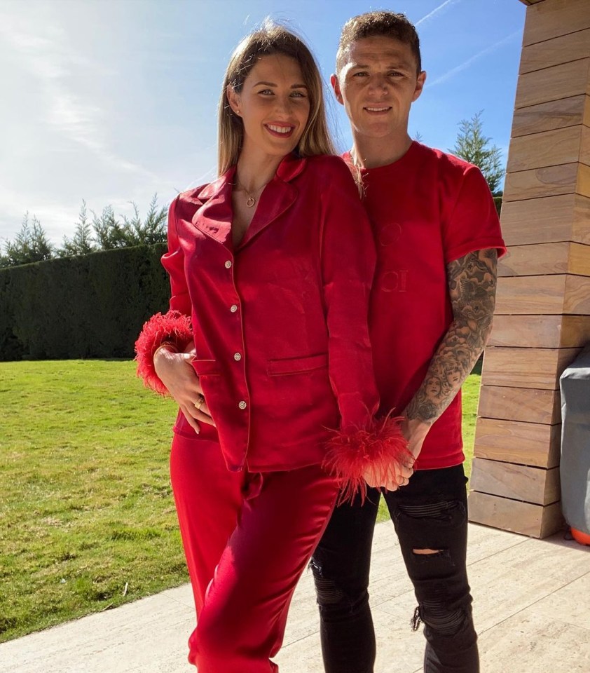Charlotte and Kieran Trippier holding hands, wearing matching red pajamas.