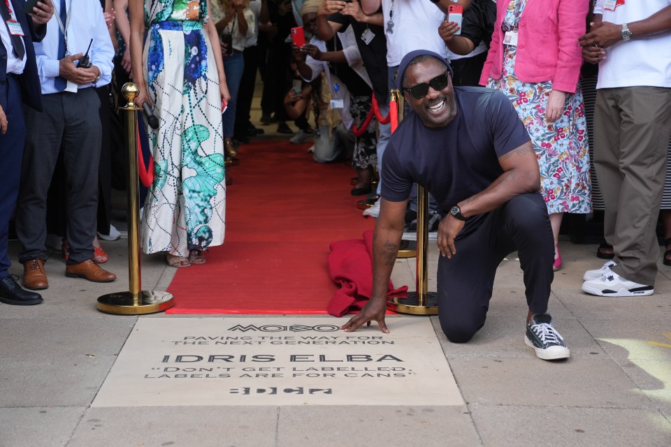 Idris Elba unveiling a commemorative MOBO stone.