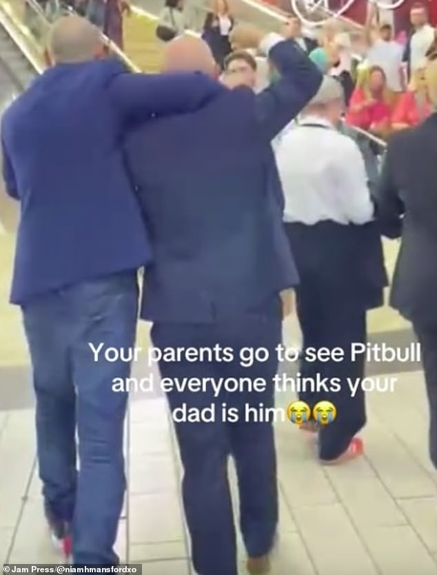 As he strolled through the busy queue, people began screaming, pointing and leaving their spots in line to follow him, convinced they were in the presence of the rapper. Pictured: Phil's friend pretending to be his bodyguard