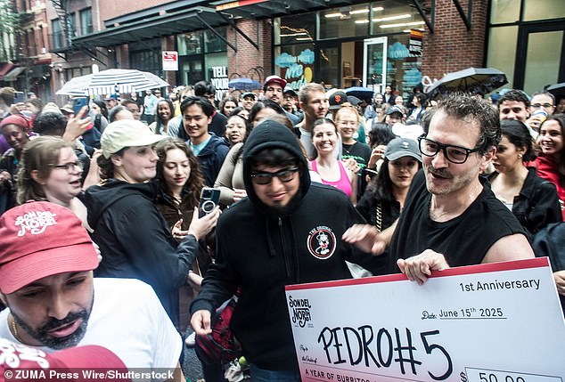 For the contest, George wore a black T-shirt with cutoff sleeves and black-rimmed eyeglasses