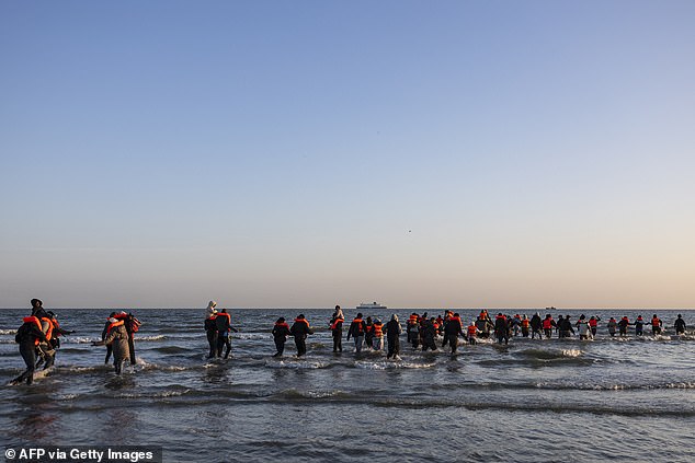 Dozens of migrants hid in the dunes before making a break for the water at the time the boat was due to arrive