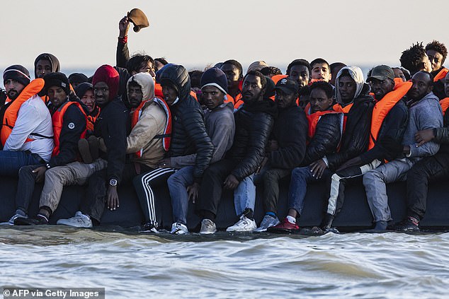 A group of migrants crowd onto a smugglers boat in Northern France