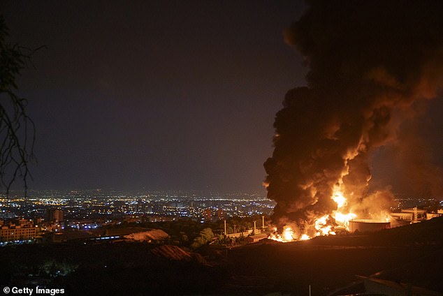 Fire and smoke rise into the sky after an Israeli attack on the Shahran oil depot on June 15, 2025 in Tehran, Iran
