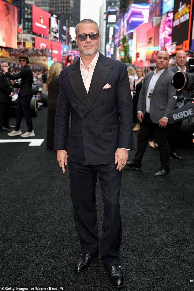 Pitt ditched his midlife crisis makeover look for the evening, wearing a slick navy tailored suit