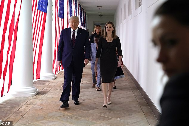 Many allies of the president have even referred to the justice (pictured right) - who has seven children, including two adopted from Haiti - as a 'DEI hire' and there are reports Trump (pictured left) himself has complained about Barrett's rulings