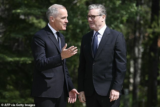 Pictured: Mark Carney greet Keir Starmer at the G7 arrival ceremony at the Pomeroy Kananaskis Mountain Lodge in Kananaskis, Alberta, Canada