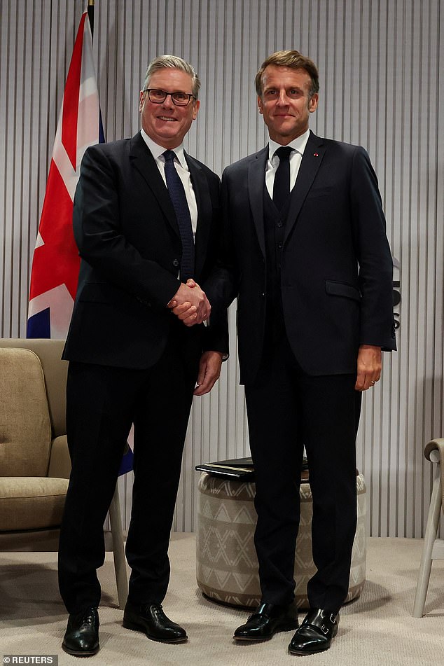 British Prime Minister Keir Starmer and France's President Emmanuel Macron shake hands during a bilateral meeting at the G7 summit