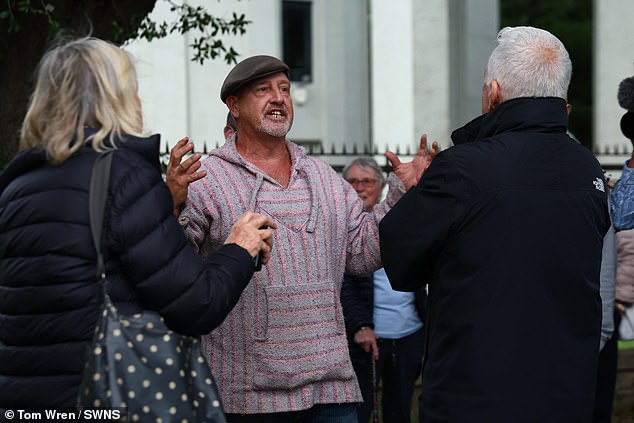 A van dweller remonstrates with protestors during Thursday's march, which 300 people attended