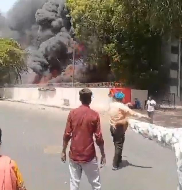Shocking footage taken just outside the medical college the plane crashed into showed the sole survivor calmly walking away as an inferno raged just a few metres behind him