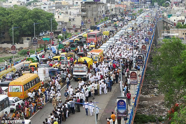 People gather for a funeral procession of former Chief Minister of Gujarat Vijay Rupani, who died when an Air India Boeing 787-8 Dreamliner plane crashed during take-off, in Rajkot, Gujarat, India, June 16, 2025