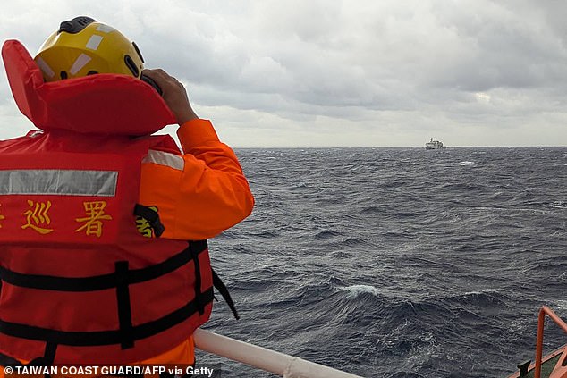 A crewmember on board a Taiwan Coast Guard ship monitoring a Chinese coast guard vessel in waters east of Taiwan