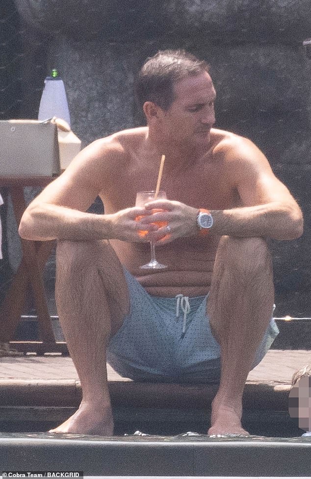 Frank sported a pair of light blue polka dot swim shorts as they relaxed by the pool