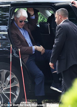 Bill Clinton seen getting out of a black vehicle at the rehearsal dinner