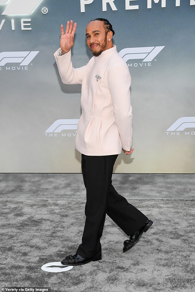 Lewis showed off his impeccable style in a pale pink jacket, black trousers and loafers