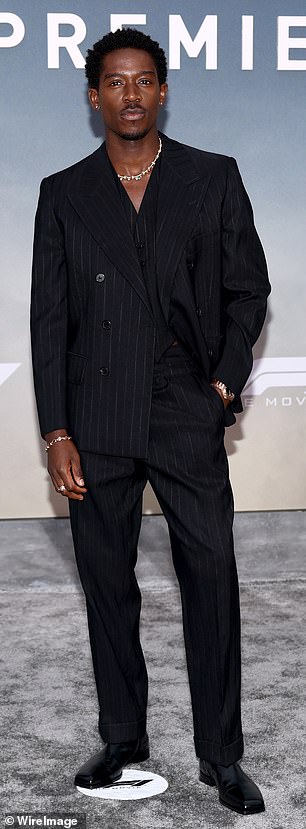 Damson worked a smart suit and artistic necklace