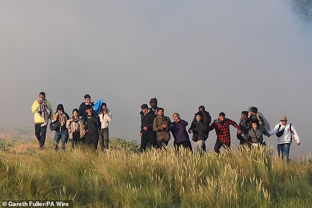 Extraordinary scenes today showed dozens of French police and coastguards looking on as men and some women crammed onto an overloaded boat off Gravelines beac