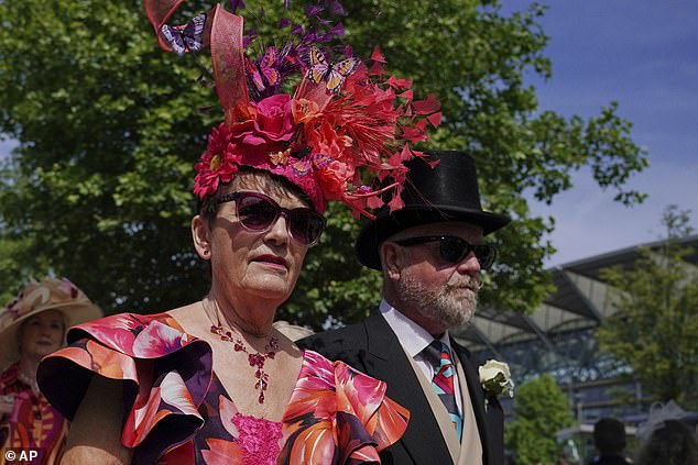Hat's off to Ascot! This lady turned heads with her statement floral headpiece teamed with a matching colourful dress