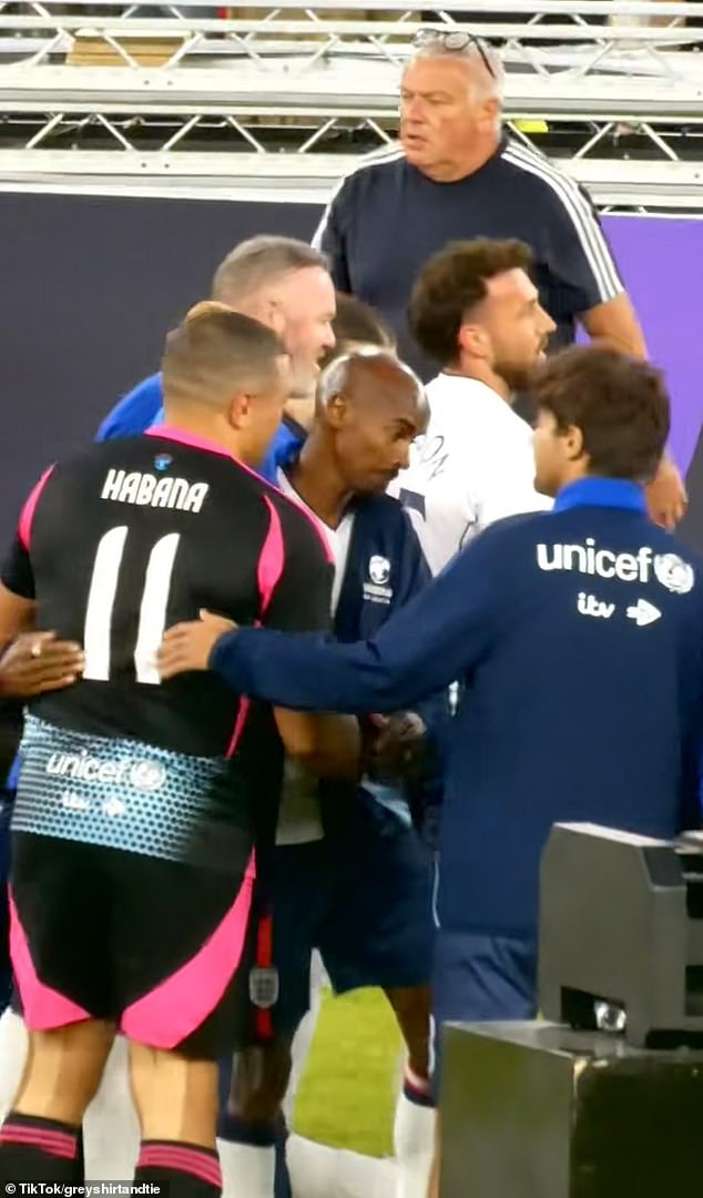 In a video obtained by MailOnline from Old Trafford on Sunday, the One Direction star is seen embracing players and coaching staff from both sets of teams before conducting an interview