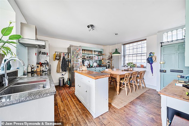 Described as a 'Tower house', the property features a kitchen with modern wall lighting and granite work surfacing as well as a selection of free-standing dressers