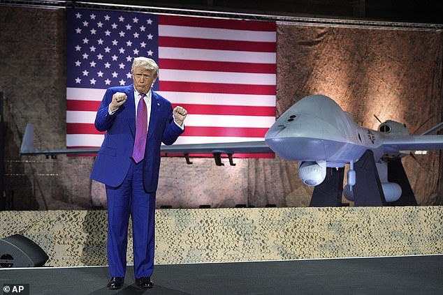 President Donald Trump gestures in front of an MQ-9 Reaper drone at the Al Udeid Air Base, Thursday, May 15, 2025, in Doha