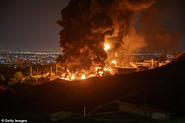 Fire and smoke rise into the sky after an Israeli attack on the Shahran oil depot on June 15, 2025 in Tehran, Iran