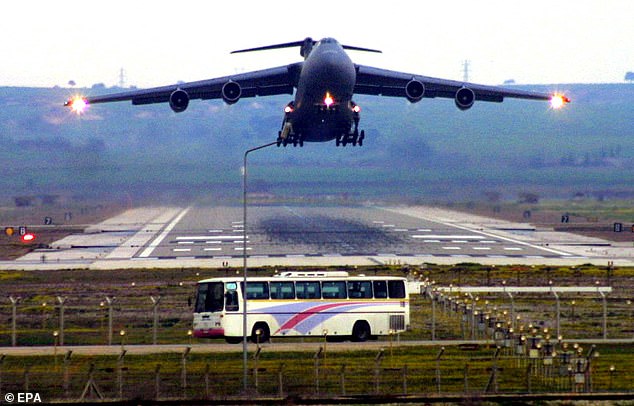 A US Airforces cargo plane C-5 takes off over a civilian bus in Incirlik, southeastern Turkey, Tuesday, 11 March 2003