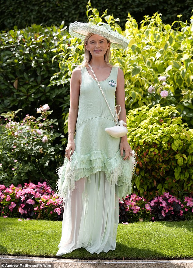 Georgia toted her essentials in a quirky bird-shaped cream bag with a crossbody pearl strap to complete her glamorous look