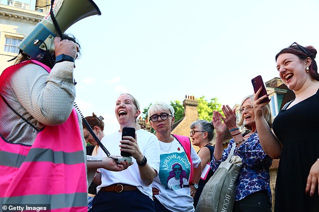 Protesters from pro-choice group 'Abortion Rights' react outside Parliament after MPs voted to decriminalise abortion on June 17