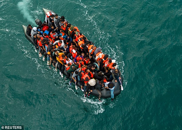 An inflatable dinghy carrying migrants makes its way towards England in the English Channel in August last year (file photo)